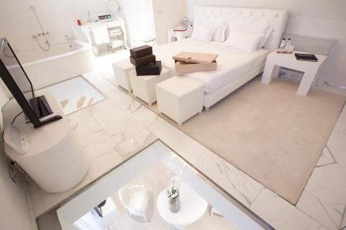 an overhead view of a living room with a bed and a tub at Boscolo Nice Hotel & Spa in Nice
