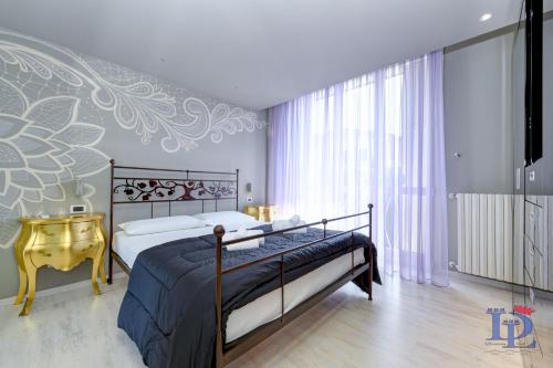 Schlafzimmer mit einem Bett, einem Tisch und einem Fenster in der Unterkunft DesenzanoLoft Villa Meraviglia in Desenzano del Garda
