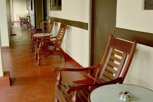 a row of tables and chairs in a restaurant at Sunny Lanka Guest House in Matara