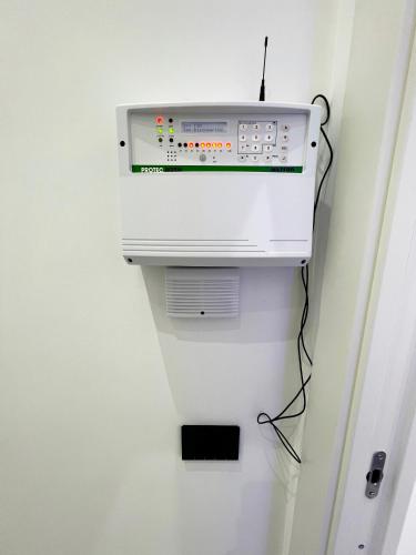 a microwave oven hanging on a wall at RaRoom Supernova H in Torre del Greco
