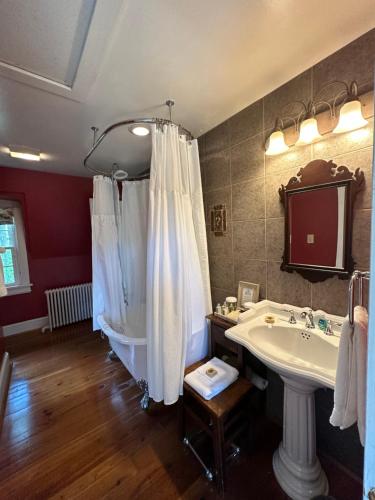 a bathroom with a white tub and a sink at Goodstone Inn & Restaurant in Middleburg