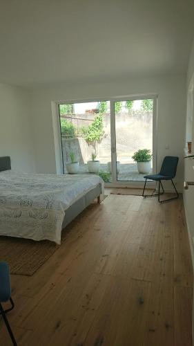 a bedroom with a bed and a large window at Ruhezeit in Stockach