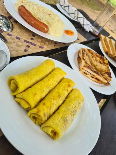 three plates of food on a table with breakfast foods at Ranakeliya Lodge - Yala in Yala