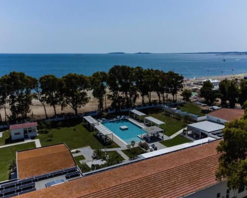 an aerial view of a resort with a swimming pool and the beach at Hotel Lido Beach in Oristano