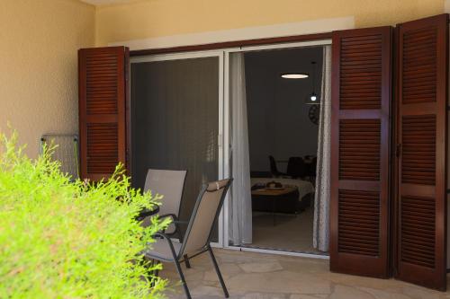a room with a sliding glass door with a chair at Daniel's Apt - Magical Views in Tsadha