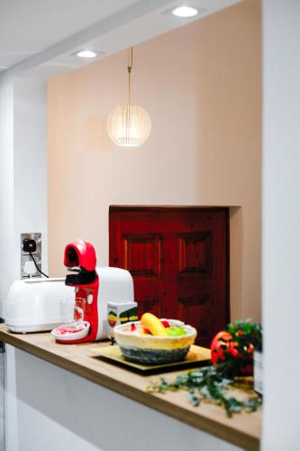 a kitchen counter with a bowl of fruit on a counter at Daniel's Apt - Magical Views in Tsadha