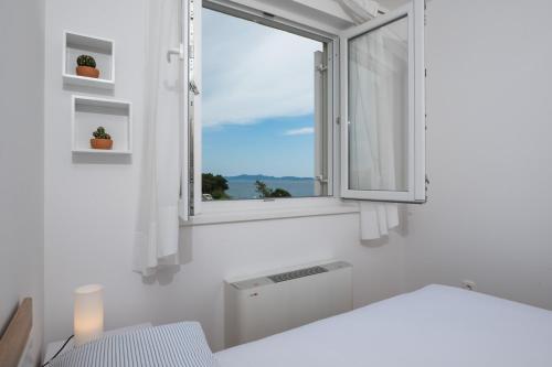 a white room with a window and a sink at Lila1 Apartments in Zadar