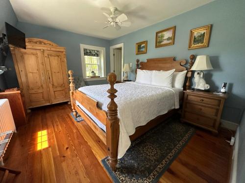 a bedroom with a large bed and a dresser and a bed sidx sidx sidx at Goodstone Inn & Restaurant in Middleburg