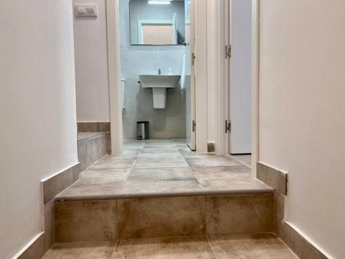 a hallway of a bathroom with a sink at Acogedor apartamento en Parbayón in Parbayón