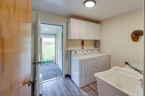 a kitchen with a washer and a door to a yard at Cozy Montana Retreat with Patio, Grill and Fire Pit! in Choteau