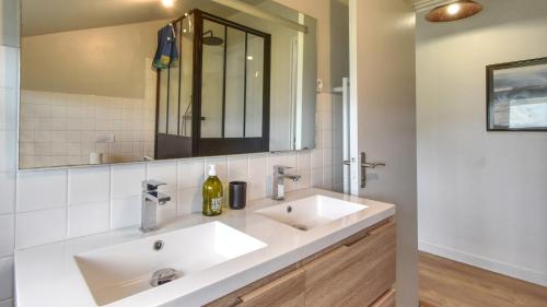 une salle de bain avec deux lavabos et un miroir dans l'établissement Grande villa 6 personnes à 200m de la mer . Récemment rénovée., à Moëlan-sur-Mer