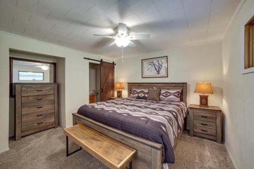 a bedroom with a bed and a ceiling fan at Cozy Montana Retreat with Patio, Grill and Fire Pit! in Choteau