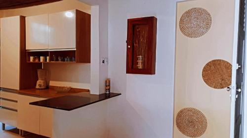 a kitchen with white cabinets and a counter top at Cantinho da Luna in Morro de São Paulo