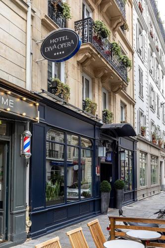 a restaurant with tables and chairs in front of a building at Hôtel Diva Opera in Paris
