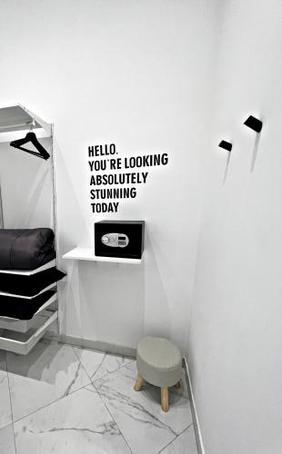a room with a chair and a wall with words on it at RaRoom Supernova in Torre del Greco