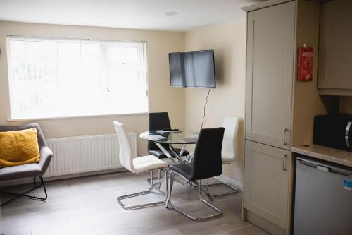 a kitchen with a table and chairs and a window at Ballycastle 7A Diamond 2 bedroom apartment in Ballycastle