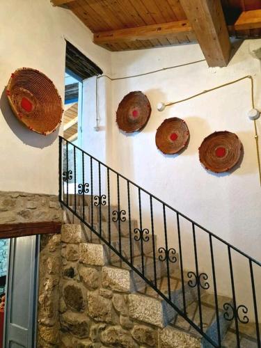 a staircase with wooden hats on the side of a building at Casa museo "Sa domu de ziu Antoneddu" in Tuili