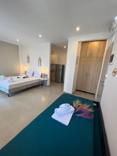 a bedroom with a bed and a blue carpet at House Kohili in Nea Vrasna