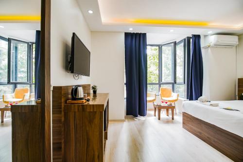 a hotel room with a bed and a tv at MITANI SUITES in Istanbul