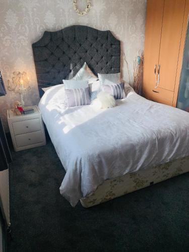 a bedroom with a large bed with white sheets and pillows at Rode house home stay in Rode Heath