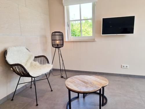 a room with two chairs and a table and a television at Vakantiehuis Aagtekerke AK13 in Aagtekerke