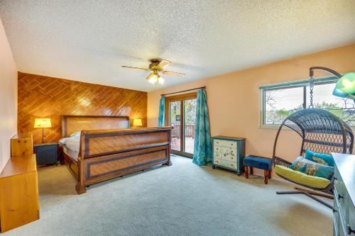 a bedroom with a bed and a ceiling fan at Colorado Springs Home with Patio and Ping Pong Table! in Colorado Springs