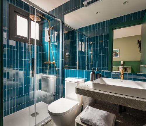 a bathroom with a toilet and a sink and a shower at BYPILLOW Twenty in Barcelona