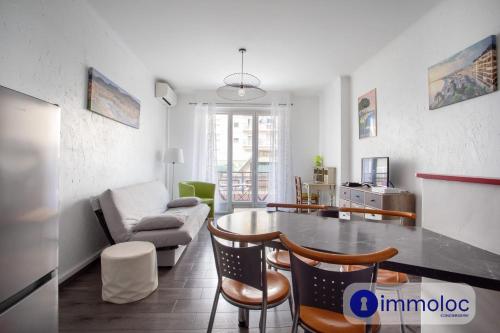 un salon avec une table, des chaises et un canapé dans l'établissement Apartment near the center Borriglione district, à Nice
