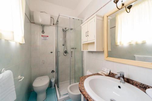 a bathroom with a sink and a toilet and a shower at Residence Vacanza Mare in Campo nell'Elba