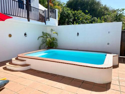 a swimming pool in the backyard of a house at Casa Colibri + Casita - Villa w/ocean views in Vieques
