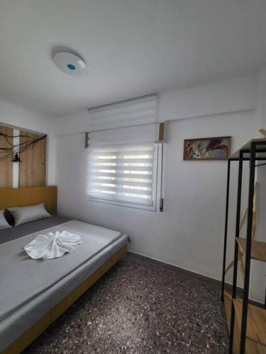 a bedroom with a bed and a window at "BenLin" 3 in Paralia Katerinis