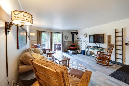 a living room with a couch and chairs and a fireplace at Riverfront Condo Near Downtown Estes Park! in Estes Park