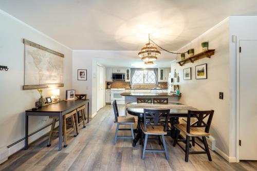 a kitchen and dining room with a table and chairs at Riverfront Condo Near Downtown Estes Park! in Estes Park