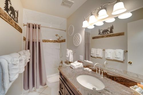 a bathroom with a sink and a toilet and a shower at Riverfront Condo Near Downtown Estes Park! in Estes Park