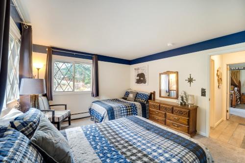 a bedroom with two beds and a mirror at Riverfront Condo Near Downtown Estes Park! in Estes Park