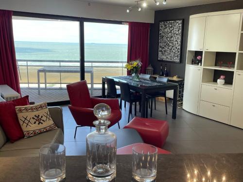 cocina y sala de estar con mesa y sillas en Bristol Palace Seaview 7e verdieping, 30 meter van strand en Blankenberge
