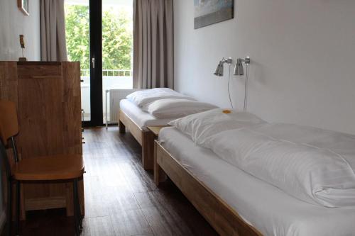 a row of beds in a hotel room at Germania-30 in Böhl