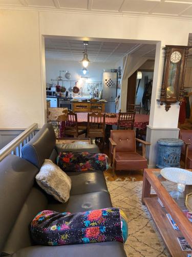 a living room with a couch and a table at Le Petit Poucet Appartement rez-de-chaussée avec grand jardin in Morzine