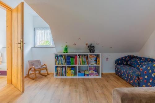 a living room with a book shelf filled with books at Holiday Home Lanita with Two Bedrooms & Terrace in Podbočje