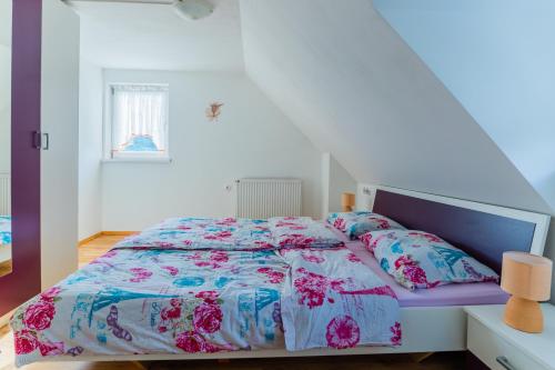 a bedroom with a bed with a floral bedspread at Holiday Home Lanita with Two Bedrooms & Terrace 