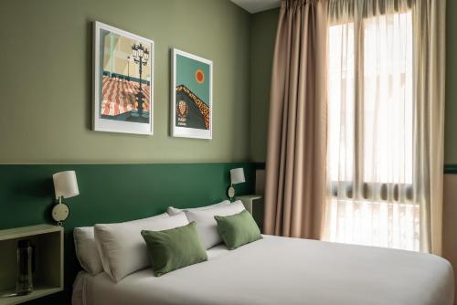 a bedroom with a large white bed with a window at BYPILLOW Twenty in Barcelona