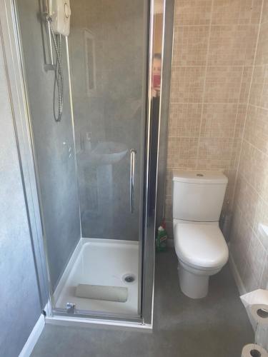 a bathroom with a shower and a toilet at Beach Walk in Berwick-Upon-Tweed