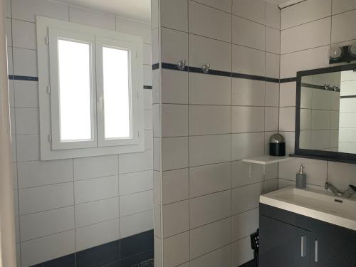 a bathroom with a sink and a window at maison en Camargue in Saintes-Maries-de-la-Mer