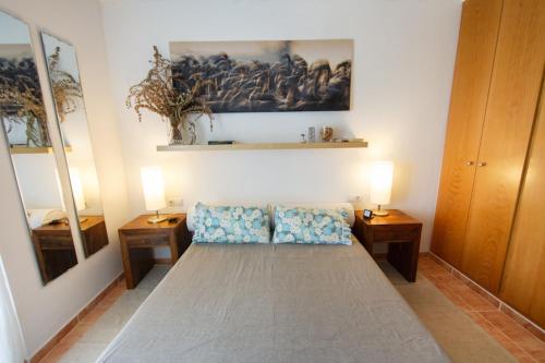 a living room with a couch and two tables at Salicornia apartament in L'Eucaliptus