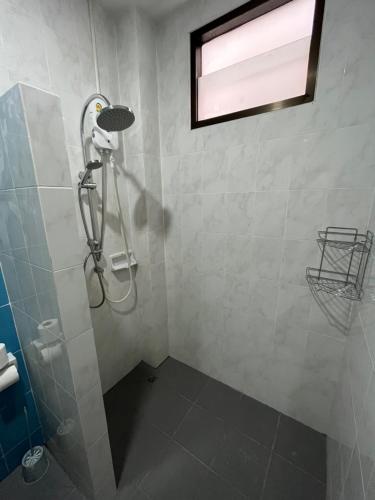 a shower with a shower head in a bathroom at Grand View Premium in Patong Beach