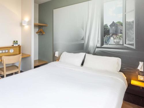 Un ou plusieurs lits dans un hébergement de l'établissement B&B HOTEL Rennes Ouest Villejean