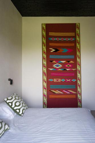 a bedroom with a bed with a painting on the wall at Groot Noordhof in Nieuwpoort