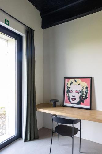 a room with a table and a chair next to a window at Groot Noordhof in Nieuwpoort