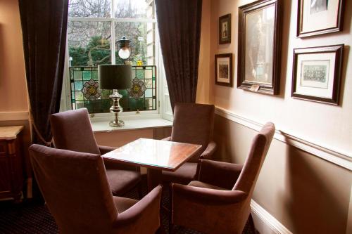 a room with chairs and a table and a window at Royal Scots Club in Edinburgh
