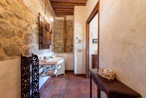 a bathroom with a sink and a toilet in a building at La Limonaia in Monte San Savino